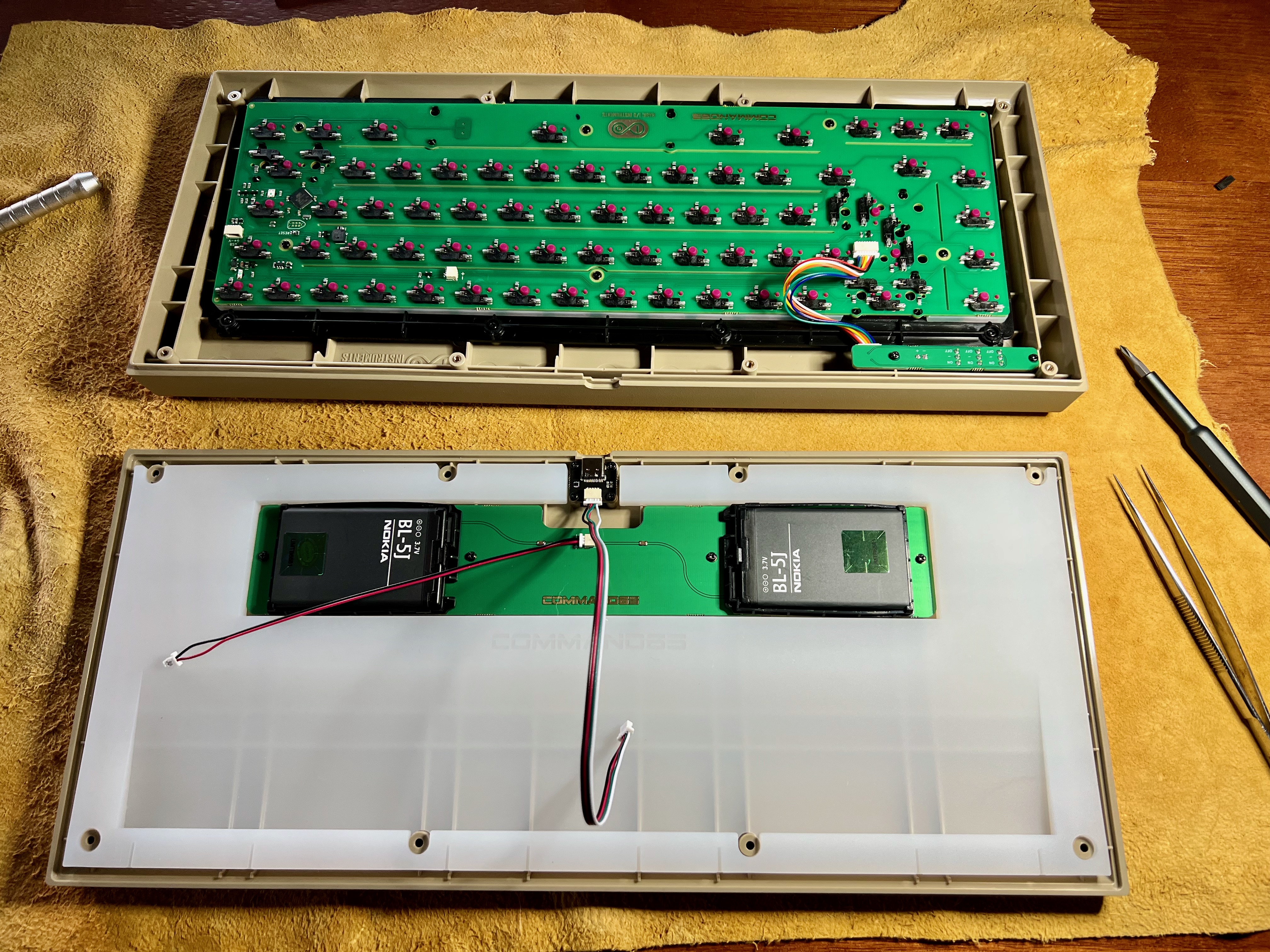 Assembling the Command 65, showing the batteries and the silicone sheet